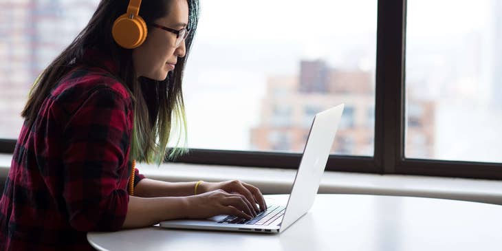 a transcriber typing out an audio recording