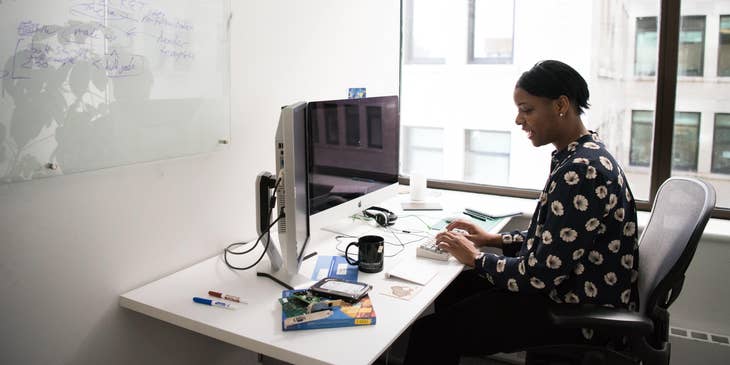 Treasurer working on budgets and financial statements on a computer while making a financial report