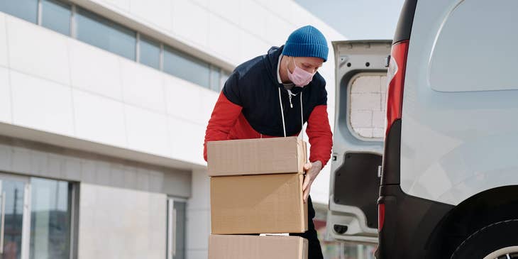 Van Salesman loading the products to the vehicle before traveling to a new route to sell the goods