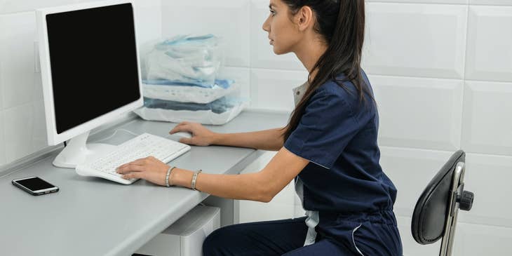 Veterinary Receptionist sitting at her workstation and eager to start her day