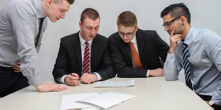Four men reviewing voluntary benefits.