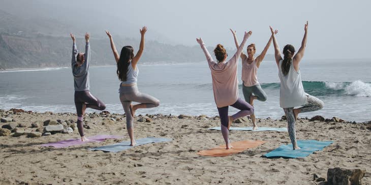 Yoga instructor holding a class on the beach